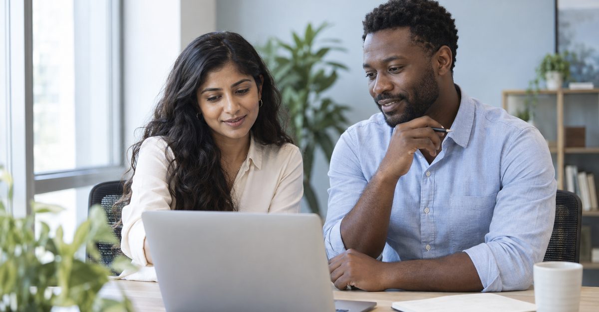 Two professionals collaborating on a laptop